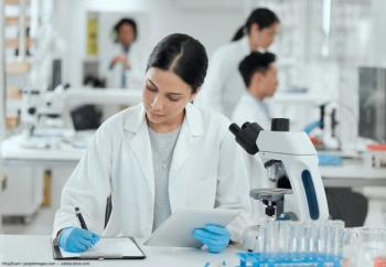 Scientist writing down data in lab Image credit: AdobeStock/KayExam/peopleimages.com