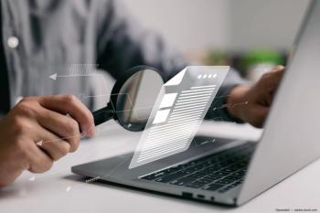 Magnifier held to laptop with document graphic Image credit: ©ipuwadol - adobe.stock.com