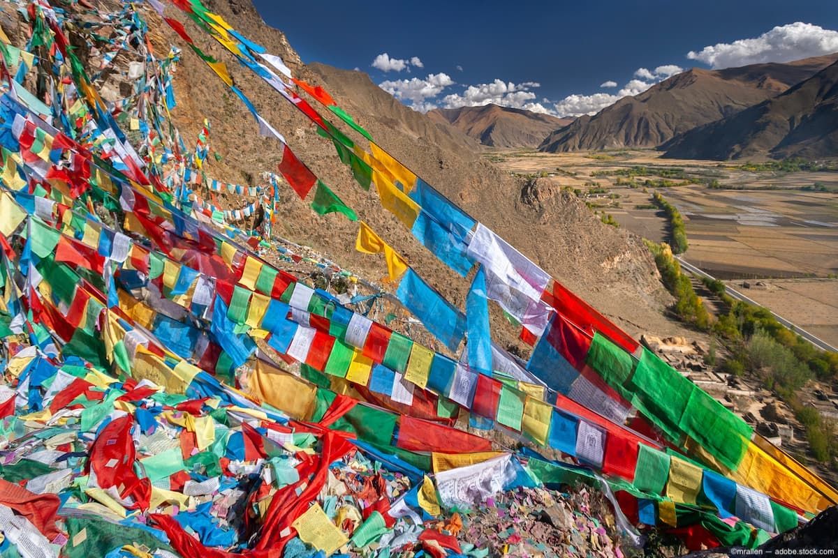 Tibetan flags on mountainside Image credit: AdobeStock/mrallen