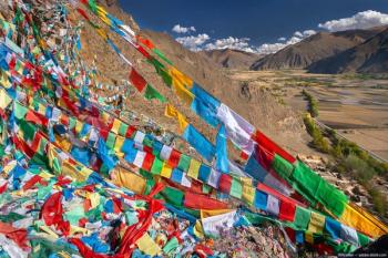 Tibetan flags on mountainside Image credit: AdobeStock/mrallen