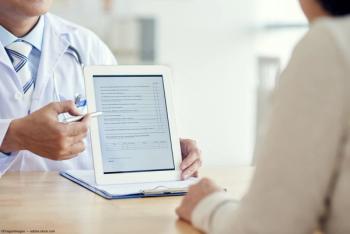 Doctor administering survey to participant Image credit: AdobeStock/DragonImages