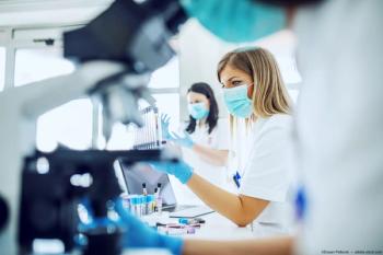 Researchers working in a lab Image credit: AdobeStock/DusanPetkovic