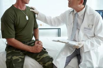 Doctor consoling veteran Image credit: AdobeStock/DragonImages