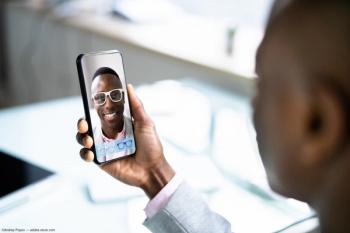 Man using phone to choose frames through virtual try-on Image Credit: ©Andrey Popov - adobe.stock.com