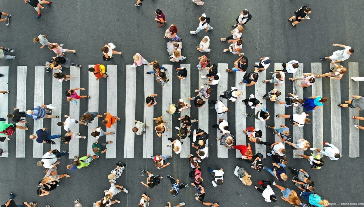 Group of people walking on crosswalk. Image credit: AdobeStock/Dmytro