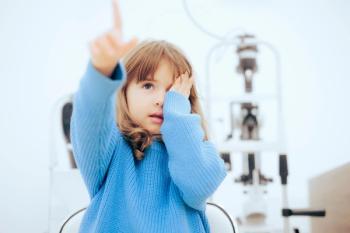 Child in optometric office pointing Image credit: AdobeStock/nicoletaionescu