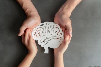 Adult and child holding paper cutout of brain Image credit: AdobeStock/Yulia/AI