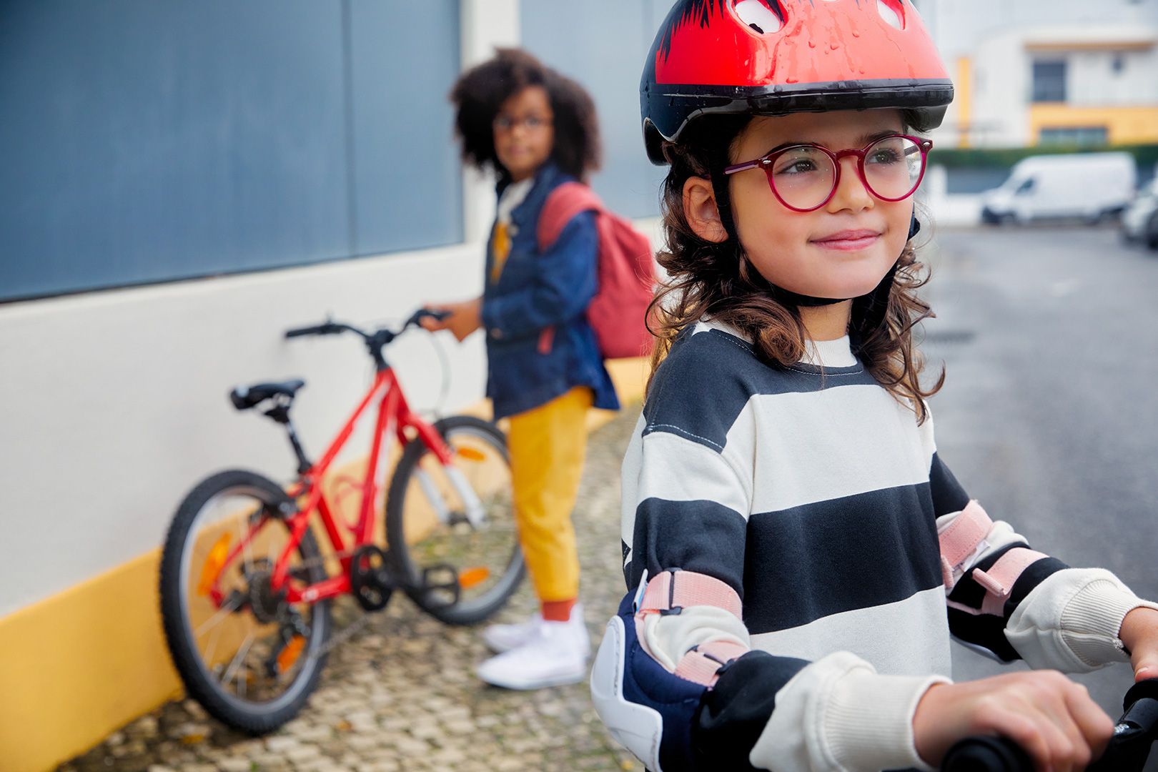 Children on bikes wearing glasses. Image credit: SightGlass Vision