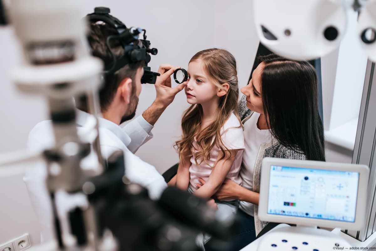 Pediatric child sitting on mother's lap and receiving eye exam from doctor Image credit: AdobeStock/Vasyl