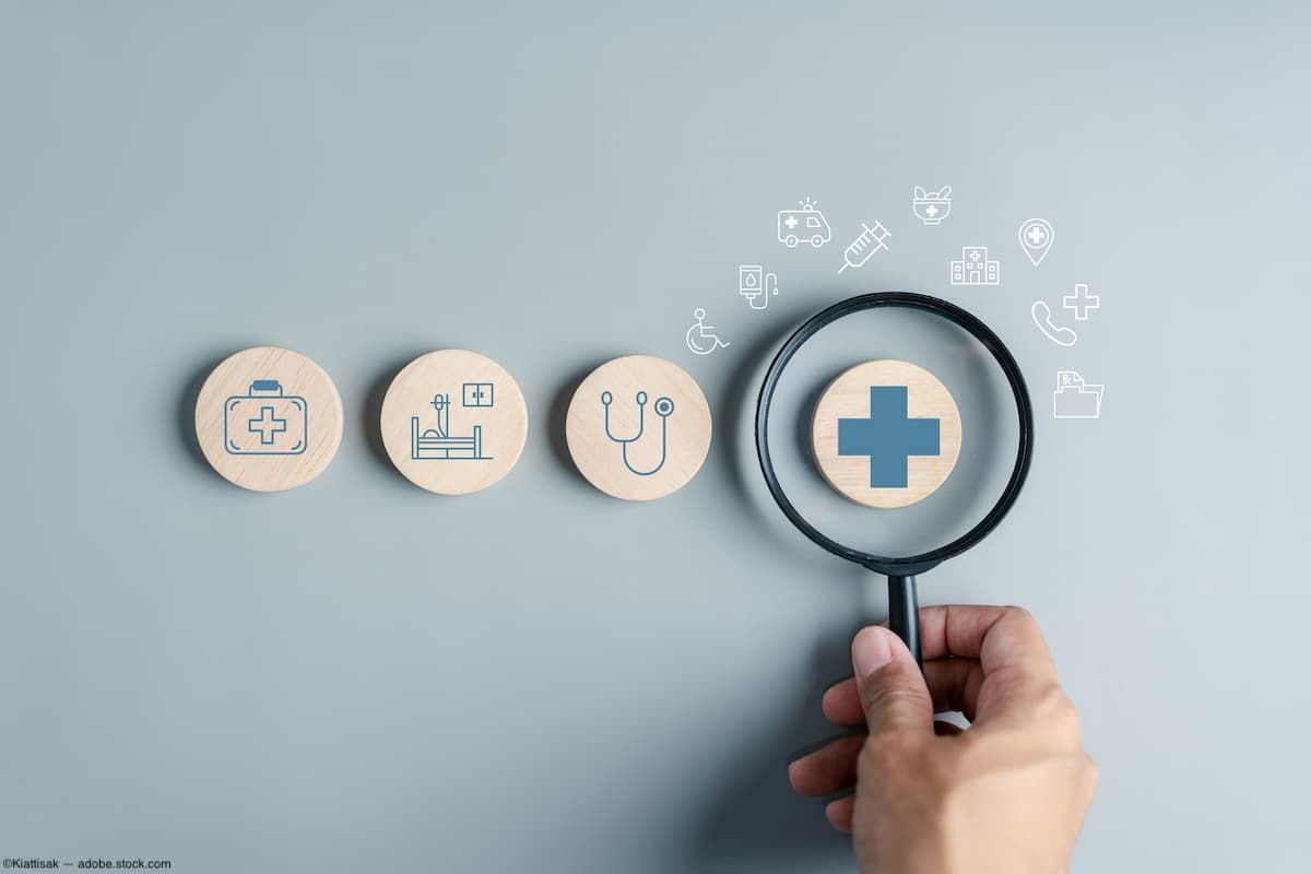 Hand with magnifying glass and medical insurance graphics Image credit: AdobeStock/Kiattisak