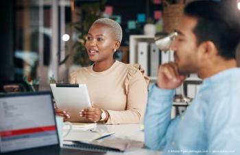 Meeting, presentation and black businesswoman briefing her team using a tablet in a boardroom planning and brainstorming. Employee, corporate and female manager or leader talking and presenting (Adobe Stock / Allistair F/peopleimages.com)
