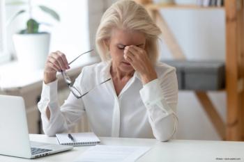 woman rubs eyes during dry eye episode due to lack of tear production - Image credit: fizkes—stock.adobe.com