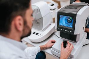Doctor looking at retinal image Image credit: AdobeStock/Vasyl