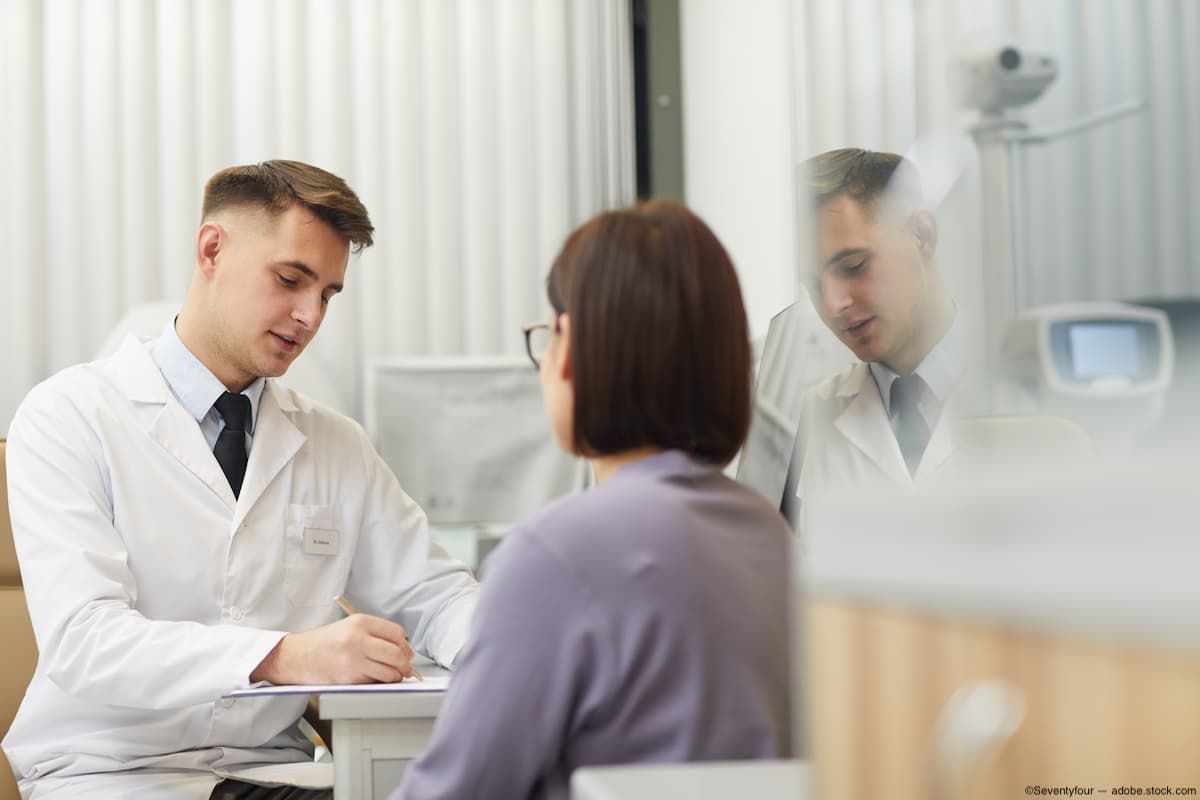 Eye doctor speaking to patient in office Image credit: AdobeStock/Seventyfour