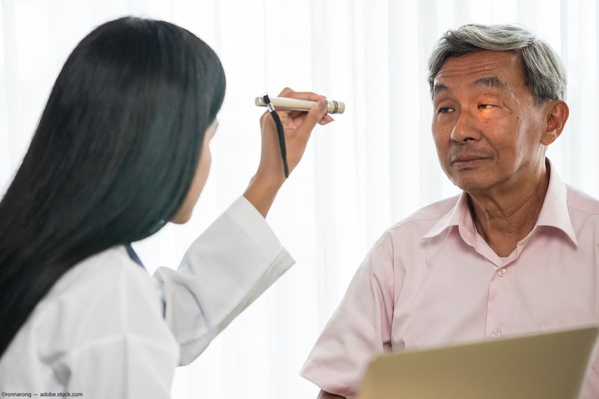 Physician shining light in patient's eye Image credit: AdobeStock/ronnarong