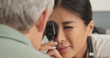 Eye care provider using ophthalmoscope on patient Image credit: AdobeStock/rocketclips