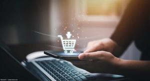 Phone held in woman's hand with shopping cart graphic Image credit: AdobeStock/Bussarin