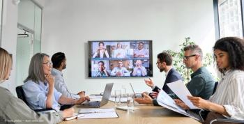 Diverse company employees having online business conference video call on tv screen monitor in board meeting room. Videoconference presentation, global virtual group corporate training concept.  (Adobe Stock / insta_photos)
