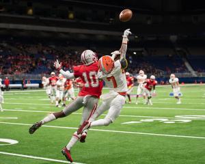 Two football players jumping for ball Image credit: AdobeStock/Joe