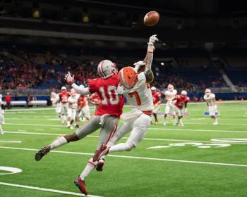 Two football players jumping for ball Image credit: AdobeStock/Joe