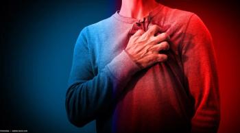 Man gripping chest on blue and red backdrop Image credit: AdobeStock/freshidea