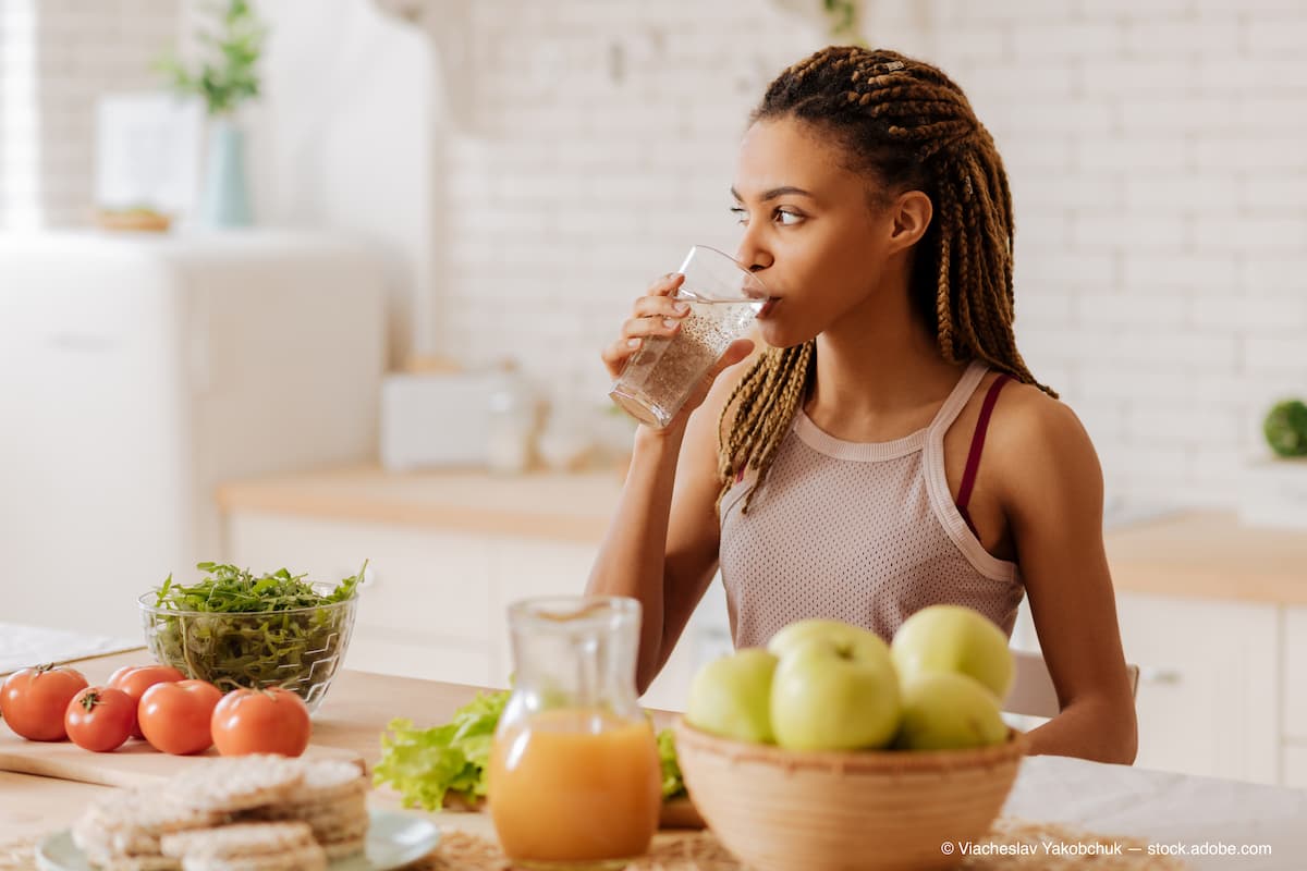 Slim and fit woman drinking water before having breakfast (Adobe Stock / Viacheslav Yakobchuk)