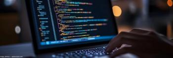 Person working on code on laptop Image credit: AdobeStock/olga_demina