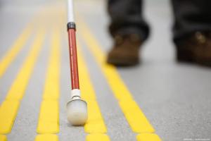 White cane on pavement Image credit: AdobeStock/zlikovec