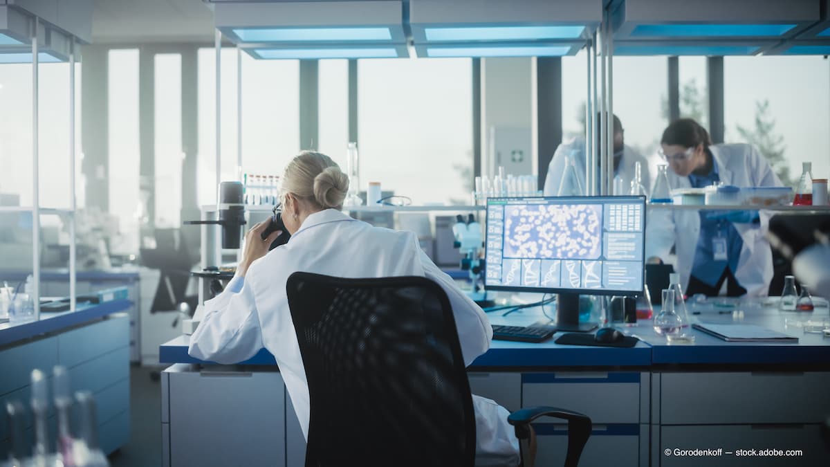 Scientist sitting at laboratory station Image credit: AdobeStock/Gorodenkoff
