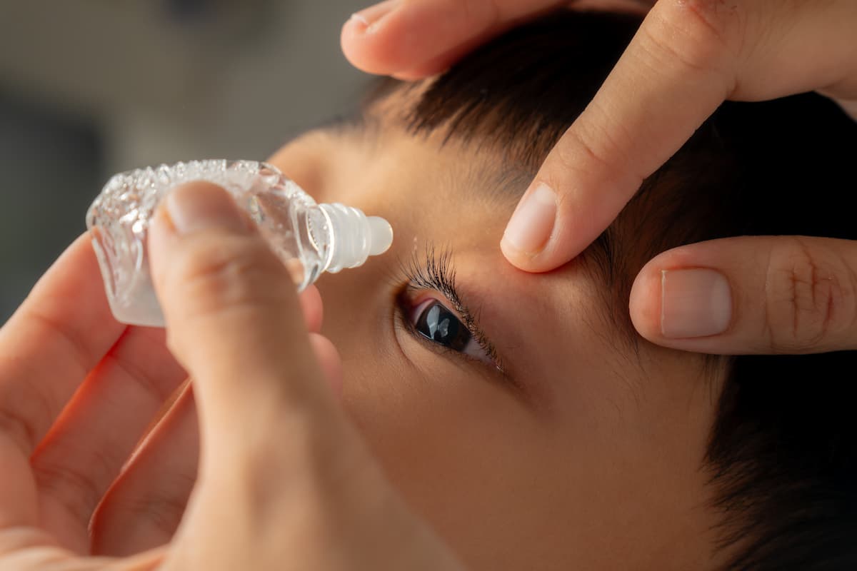 Child having drops administered into eye Image credit: AdobeStock/Dipo