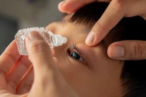 Child having drops administered into eye Image credit: AdobeStock/Dipo