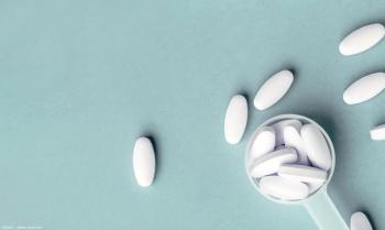 White pills in measuring cup Image credit: AdobeStock/nucia