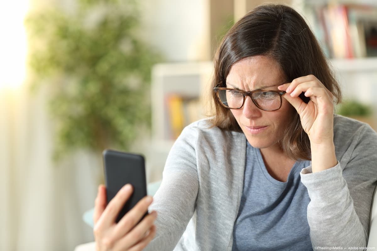 Woman with glasses holding phone Image credit: ©PheelingsMedia - adobe.stock.com