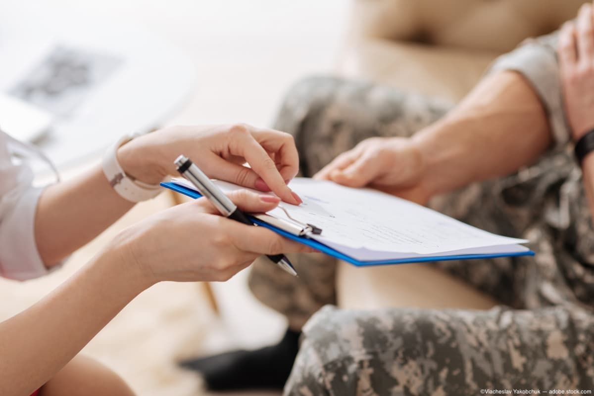 Military personnel taking clipboard from medical professional Image credit: AdobeStock/ViacheslavYakobchuk