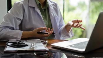 Doctor working at desk Image credit: ©Pichsakul - adobe.stock.com