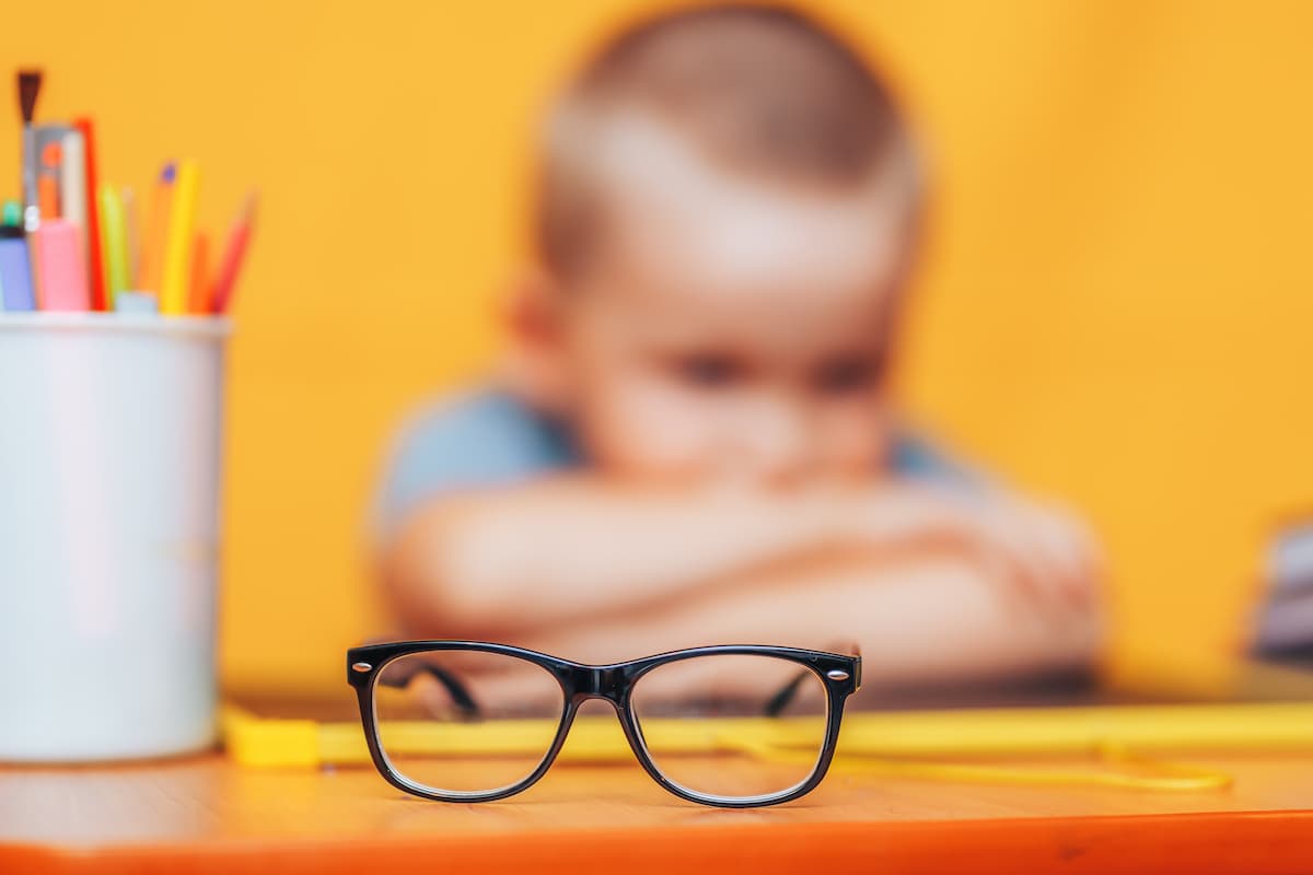 Child at table with glasses Image credit: AdobeStock/Anastassiya