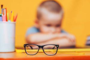 Child at table with glasses Image credit: AdobeStock/Anastassiya