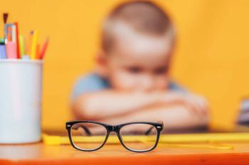 Child at table with glasses Image credit: AdobeStock/Anastassiya