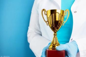 Clinician holding award Image credit: ©yta - adobe.stock.com