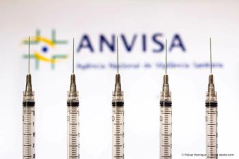 March 30, 2021, Brazil. In this photo medical syringes is seen with National Health Surveillance Agency (Anvisa) logo displayed in the background. (Adobe Stock / Rafael Henrique)