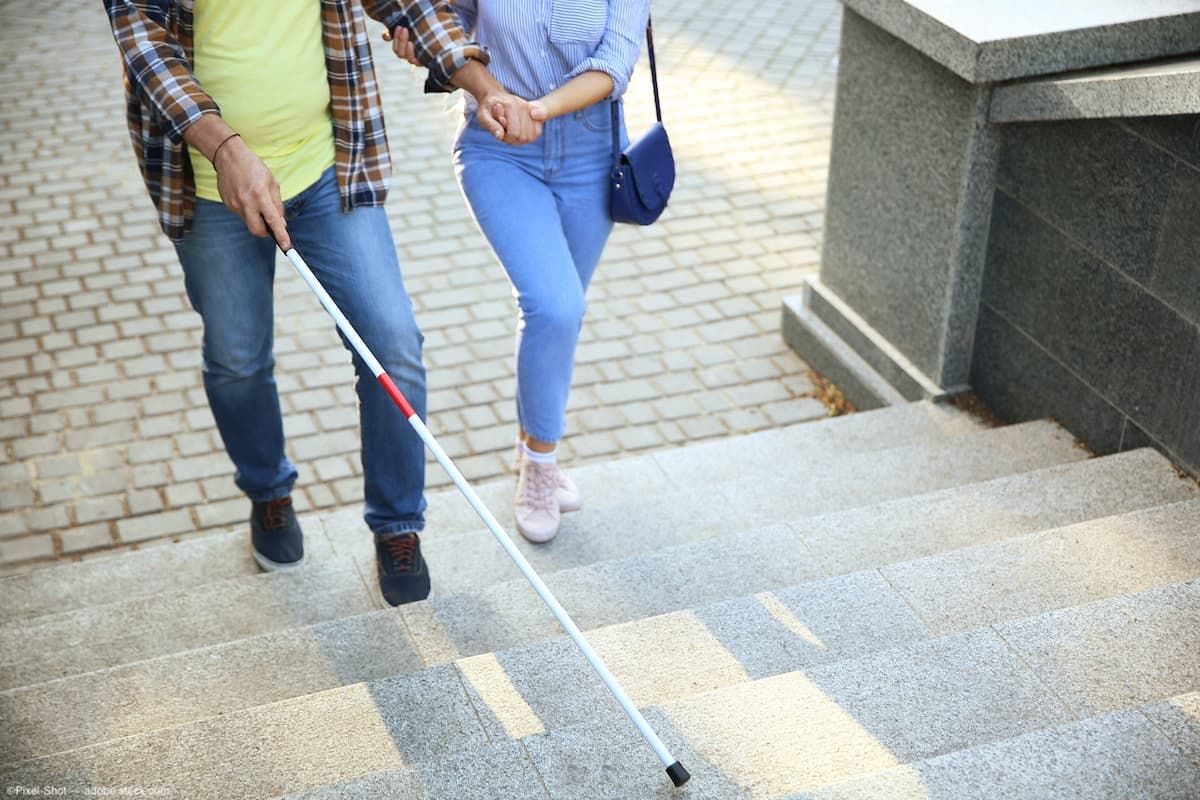 Man using white cane up stairs Image credit: AdobeStock/Pixel-Shot