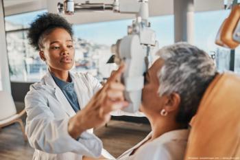 Physician conducting eye exam on patient. Image credit: AdobeStock/Coetzee/peopleimages.com