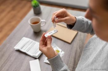 woman takes COVID-19 test at home - Image credit: Adobe Stock / ©Syda Productions