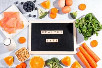 Fruits and vegetables surrounding "healthy eyes" sign Image credit: AdobeStock/MariaShchipakina