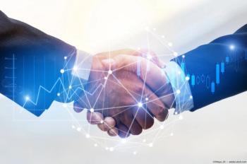 Businessmen shaking hands with digital graphic overlay Image credit: AdobeStock/Vittaya_25