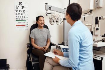 Optometrist speaking to patient in chair of office Image credit: ©Nicholas Felix / peopleimages.com - adobe.stock.com