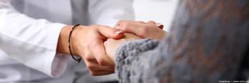 Doctor holding patient's hands Image credit: AdobeStock/megaflopp