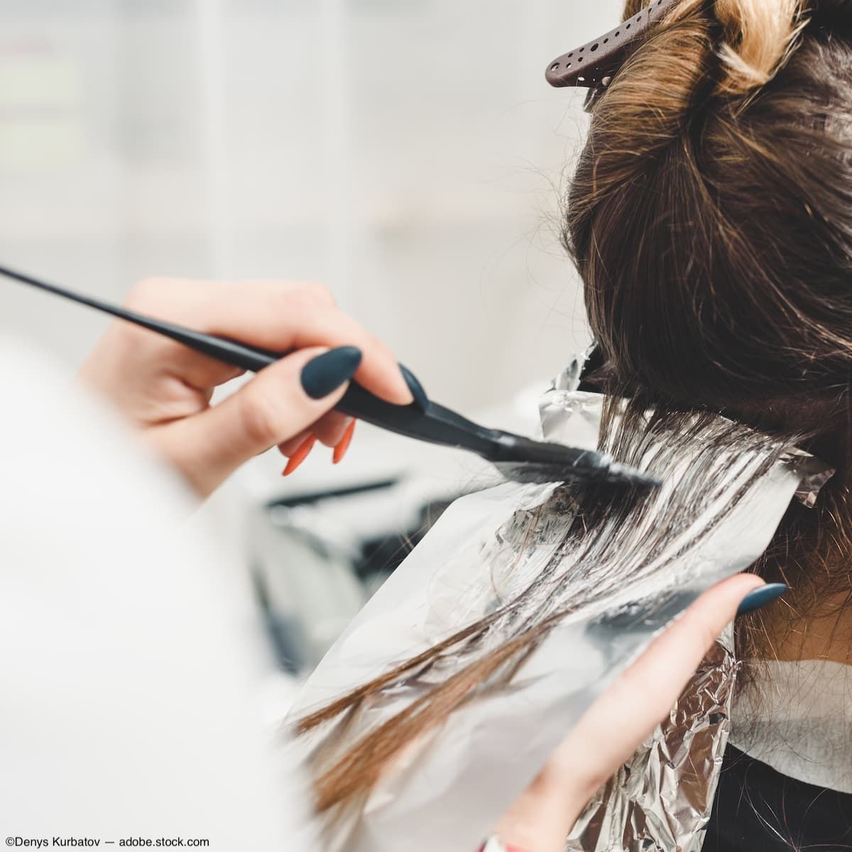 Hair dye being applied to hair Image credit: AdobeStock/DenysKurbatov