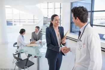 Doctors, administrators shaking hands in office Image credit: ©Chris Ryan/KOTO - adobe.stock.com