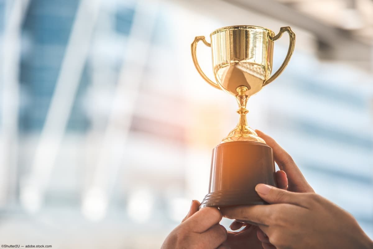 Hands holding up trophy Image credit: AdobeStock/Shutter2U